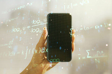 Double exposure of creative scientific formula concept and hand with cell phone on background,...