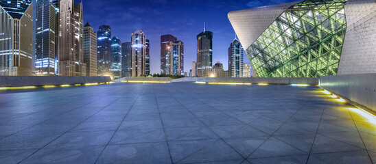 City square floor and modern commercial building scenery at night in Shanghai. Famous financial...
