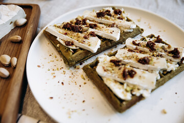 Pistachio waffles with pecans and camembert cheese on a plate