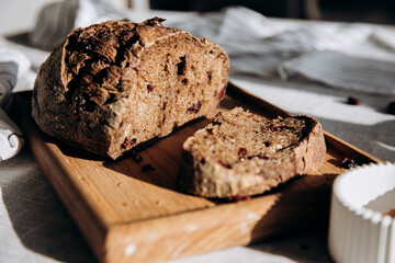 Homemade pate and bread with cranberries and raisins on a wooden board