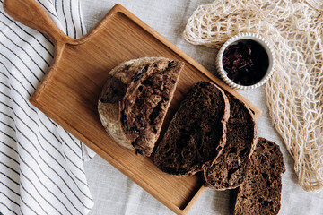 Homemade pate and bread with cranberries and raisins on a wooden board