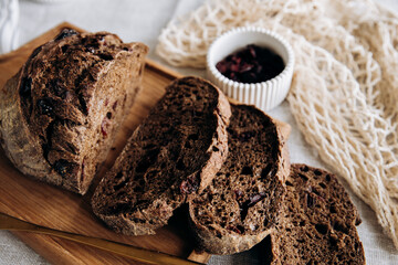Homemade pate and bread with cranberries and raisins on a wooden board