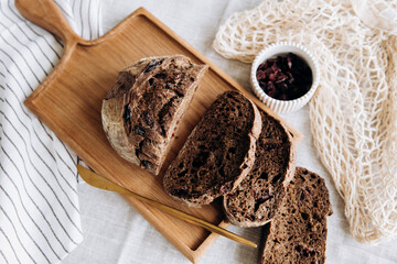 Homemade pate and bread with cranberries and raisins on a wooden board