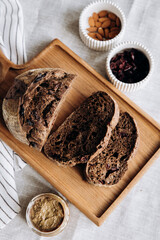 Homemade pate and bread with cranberries and raisins on a wooden board