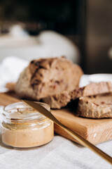 Homemade pate and bread with cranberries and raisins on a wooden board. Selective focus