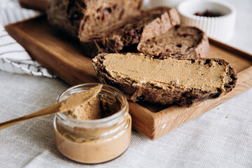Homemade pate and bread with cranberries and raisins on a wooden board. Table setting, cafe, restaurant, menu