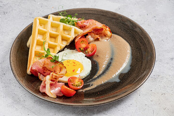 belgian waffle with fried egg and bacon
