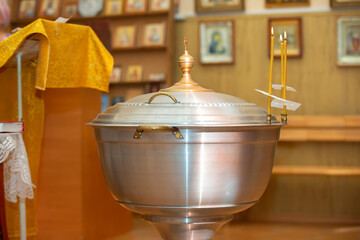 Metal bathtub for Orthodox infant baptism. Religious font. - obrazy, fototapety, plakaty