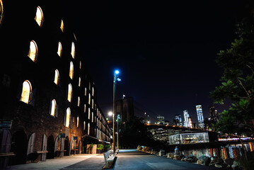 The Brooklyn Bridge and the Facade of the Time Out Market Building at Night - DUMBO, Brooklyn, New York City