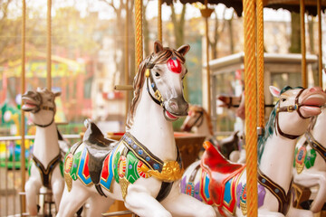 Fototapeta na wymiar Vintage carousel horse in the sun. Childhood memories.