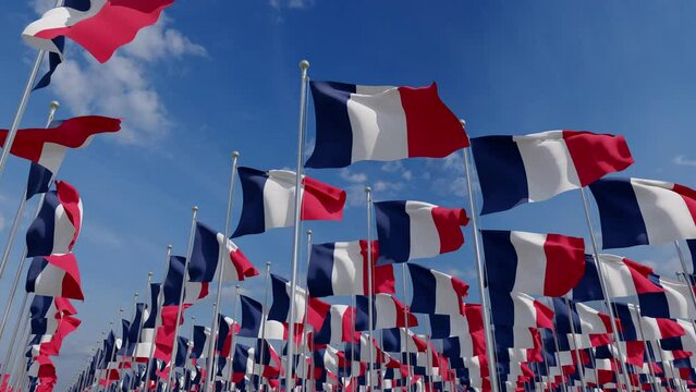 Flags of France blowing in the wind. Flags of France waving over a blue sky. France Flags on pole for Independence day. The symbol of the state on wavy fabric.