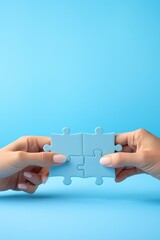 Two hands holding puzzle pieces to complete the puzzle
