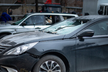 Fototapeta premium Dnepr, Ukraine – January 6: Russian drones attacked the Dnieper. Burnt and damaged cars in the Dnieper. Utility services clean up the aftermath of the attack on the city.