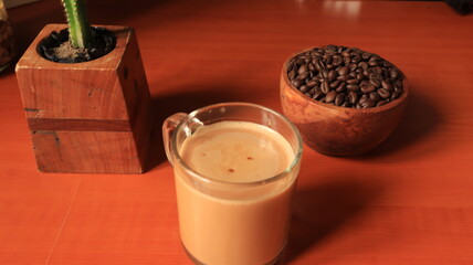 Indonesian coffee on wooden background. Coffee Beans in wooden container.