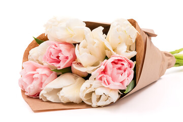 Bunch of white and pink double tulips wrapped in recycled brown paper isolated on white background. Tulips bouquet.