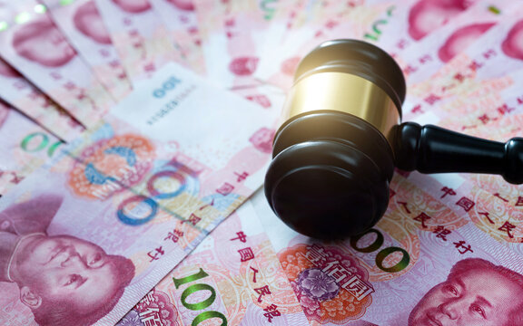 Gavel on stack of renminbi
