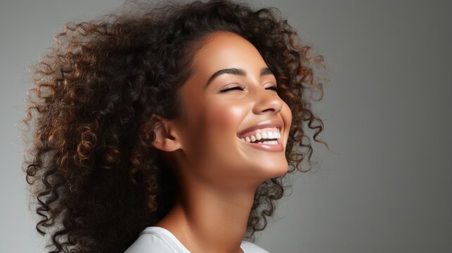 Beautiful face of young brown skin woman smiling and curly hair