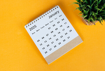 January 2025 desk calendar on yellow background. Directly above. Flat lay