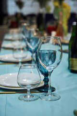 The setting of the festive table. Food and dishes. Festive glasses for drinks.