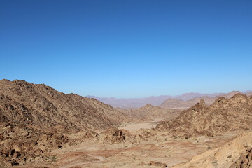 A beautiful  daytime view of the mountain range adjacent to Split Rock in Tabuk, Saudi Arabia.