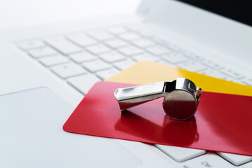 Football red and yellow cards on laptop keyboard