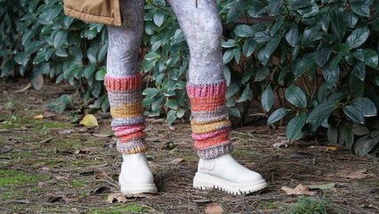 walking in the woods with colorful crochet legwarmers