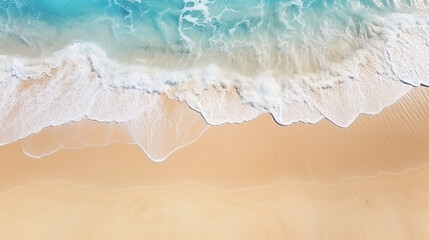 Fototapeta na wymiar Waves hitting the sandy beach clear sand beach from above with light blue transpare