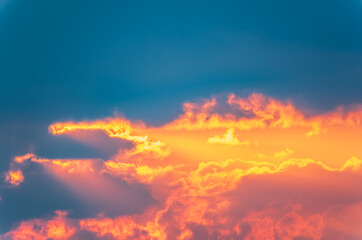 Naklejka na ściany i meble Dramatic cloudy sky background. Orange cloudy sunset sky.