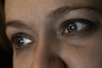 Fototapeta premium Close-up of girl's face with computer screen reflection in eyes