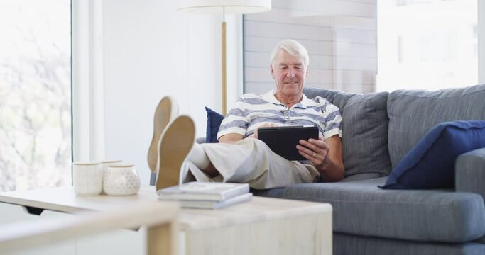 Relax, tablet and senior man on a sofa with social media, search or ebook in his home. Smile, rest and old male person with digital, app or online shopping, scroll or check sign up streaming service