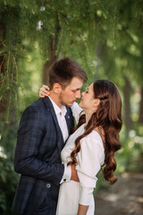 A man and woman kissing outdoors, possibly in a romantic or wedding context. 5142