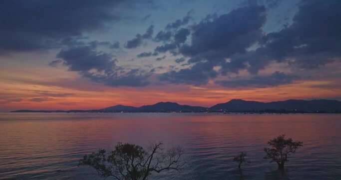 aerial view reflection of colorful cloud in bright sky of sunset above the ocean at Khao Khad Phuket. 
Majestic sunset or sunrise landscape Amazing light of nature background. 
fantastic sky texture.