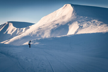 Photographer takes picture of snowy slopes in Carpathian mountains, Ukraine, Europe. Cold winter...