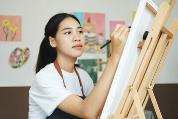 Crafting Inspiration: Female Artist Sketching and Painting in Workshop