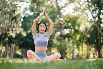 Portrait of young woman practicing yoga in garden.female happiness.  in the park blurred background.