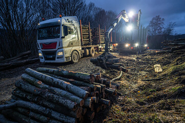 Loading wood onto a truck at night.