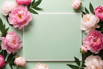 Deurstickers Pioenrozen Greeting card mockup and beautiful pink peonies flowers frame on pastel green background with copy space. Empty blank sheet card mock up for holiday greetings. Valentine's day, Mother's day, birthday