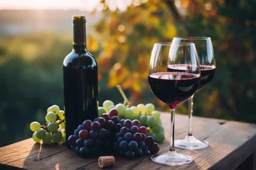 Fotobehang Glass of wine against the backdrop of a vineyard © uladzimirzuyeu