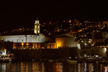 Amazing view of Dubrovnik old city and the boats in a marina in the evening. Travel destination in Croatia.