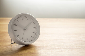 Silver alarm clock on wood table background