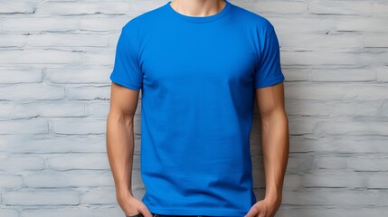 Man wearing blue t shirt mockup template in print design studio, isolated on gray wall
