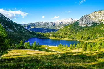 Fototapeten Großsee on the high plateau of the Tauplitzalm. View of the lake at the Toten Gebirge in Styria. Idyllic landscape with mountains and a lake on the Tauplitz.  © Elly Miller