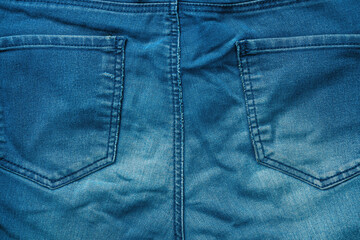 Blue denim jeans trousers back pockets as background