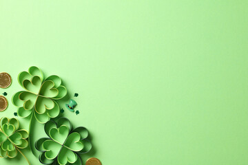 St patricks day clover and gold coins on green background.