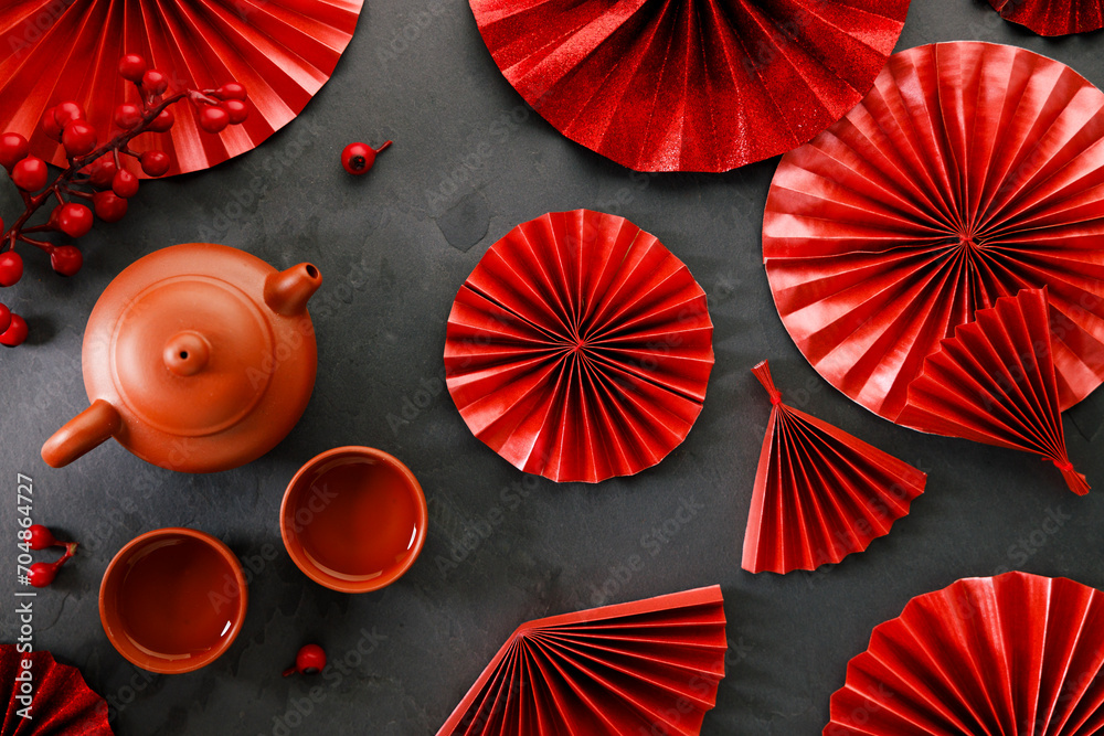 Wall mural Chinese new year festival decorations with classic clay teapot and red Chinese folded fans.