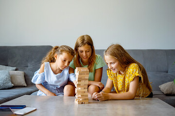 Family playing board game at home. Fun indoor activity for summer vacation. Educational toys.
