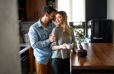Plant care. Nature protection concept. Smiling environmentally friendly couple with houseplants.
