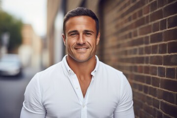 Portrait of handsome young man in white shirt smiling and looking at camera