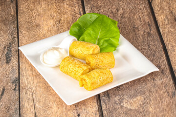 Stuffed pancakes with cream sauce