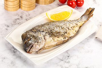 Baked Dorado fish served lemon